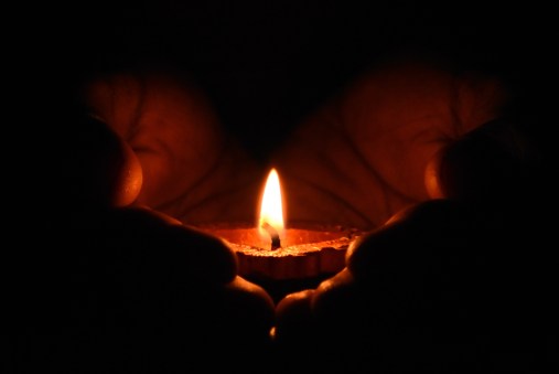 tealight-candle-on-human-palms-783200