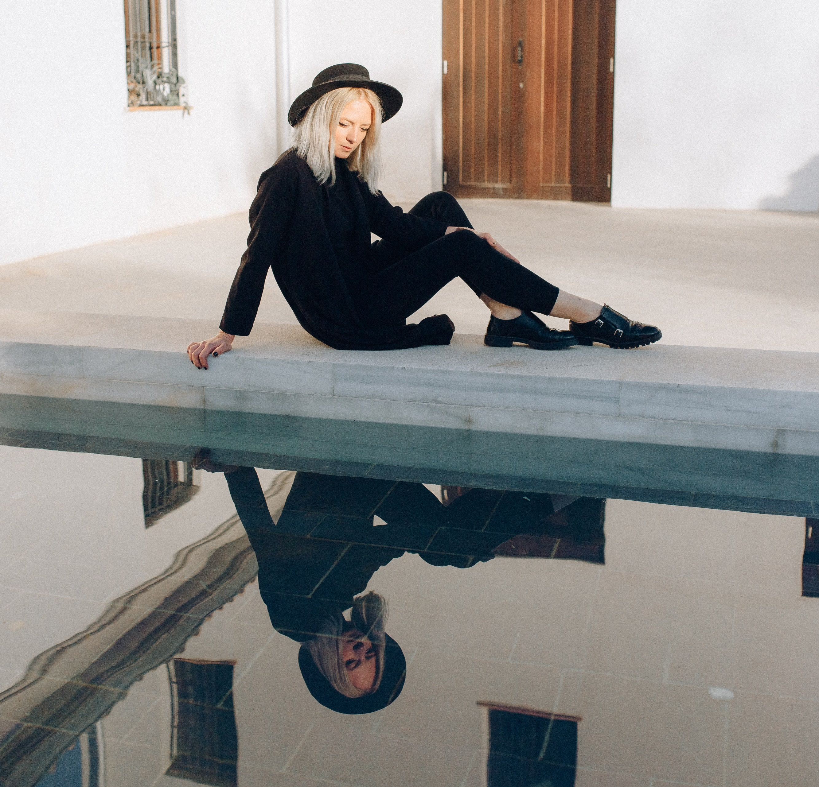 photo-of-woman-sitting-by-the-pool-4450347